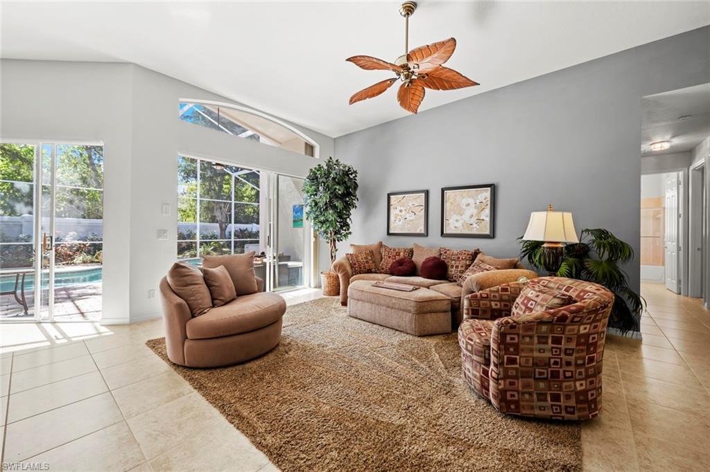 9006 Whitfield Drive Estero, FL 33928 - Photo 7 of 43 a living room with furniture ceiling fan and a large window