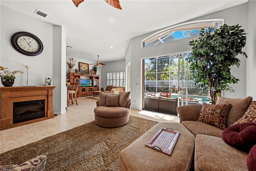 9006 Whitfield Drive Estero, FL 33928 - Photo 8 of 43 a living room with furniture and a fireplace