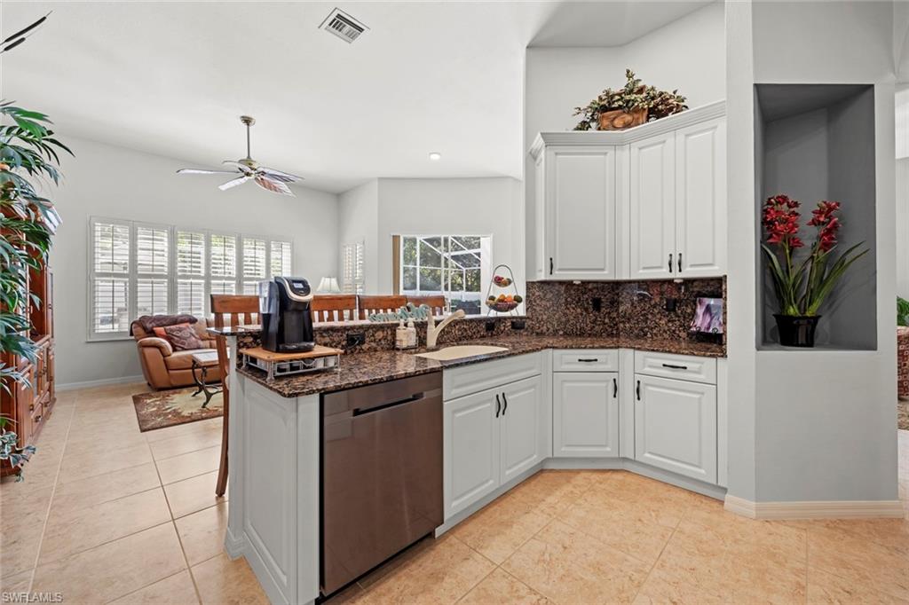 9006 Whitfield Drive Estero, FL 33928 - Photo 10 of 43 a kitchen with stainless steel appliances granite countertop a stove a sink and a refrigerator