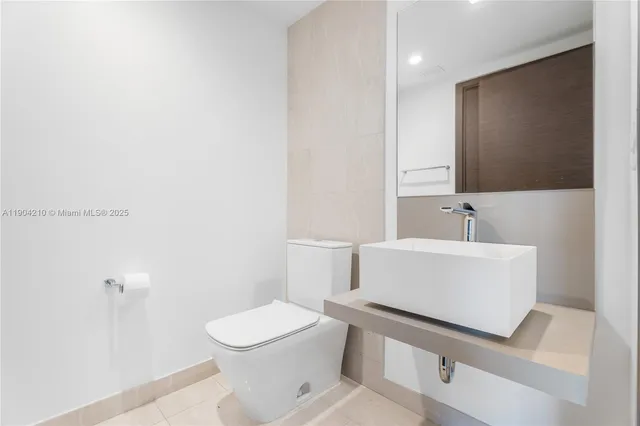 a bedroom with a bed and a lamp next to a large window