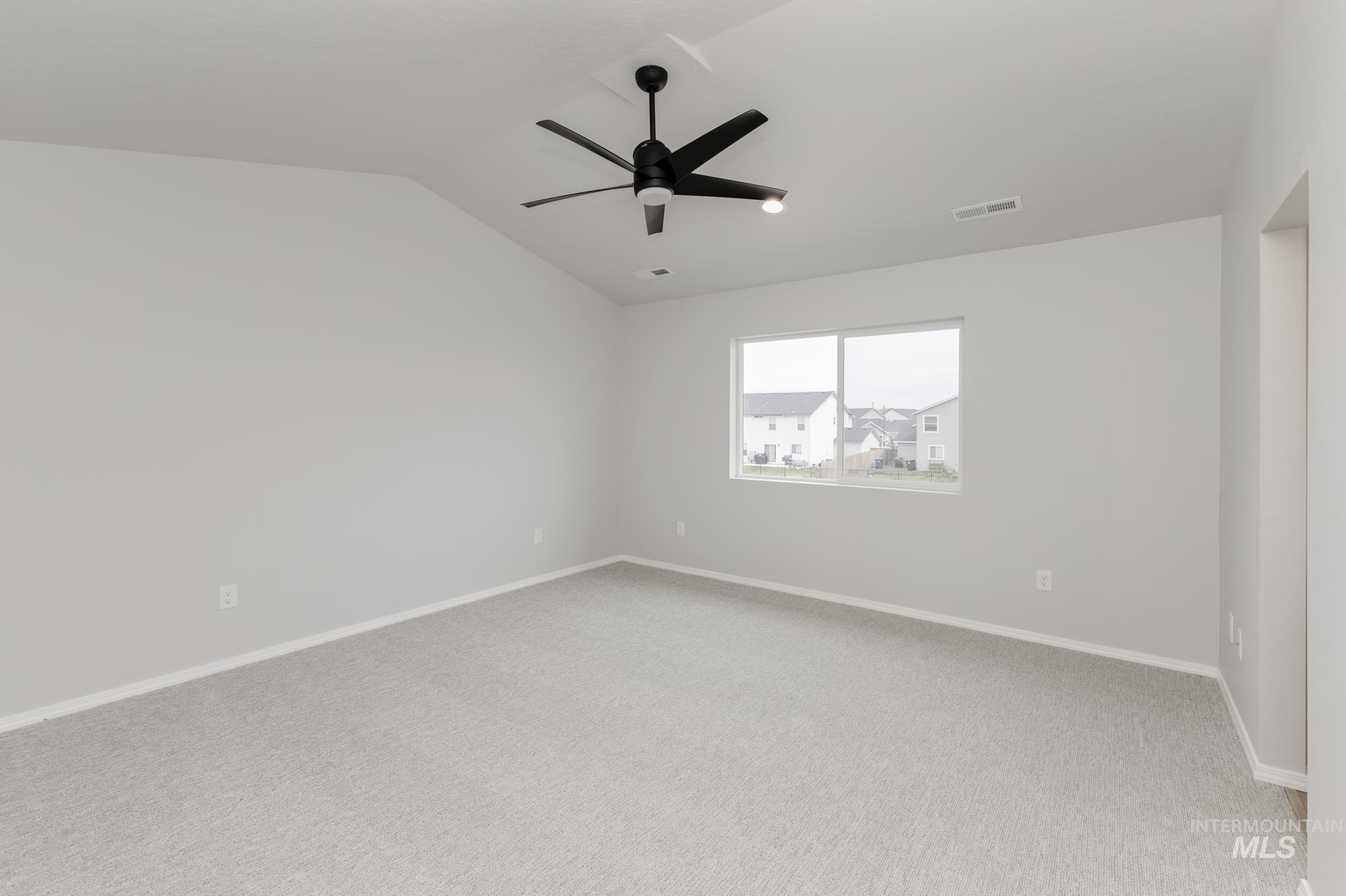 12842 Ropers Street Nampa, ID 83651 - Photo 23 of 29 Spacious room featuring light gray carpeting, neutral wall finishes, and a contemporary ceiling fan with integrated lighting
