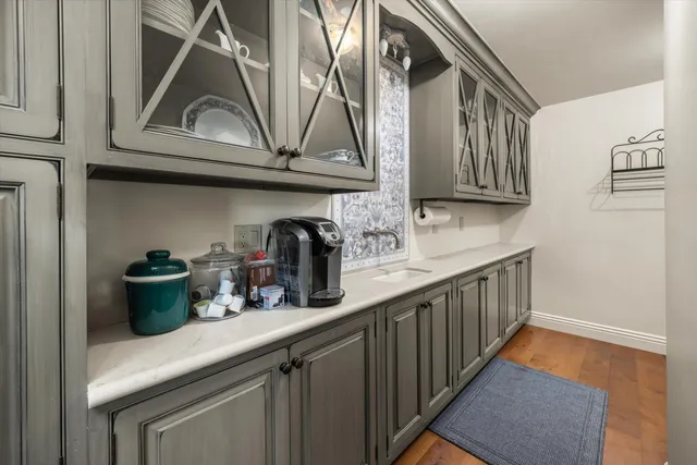 a kitchen with stainless steel appliances granite countertop a sink a stove and cabinets