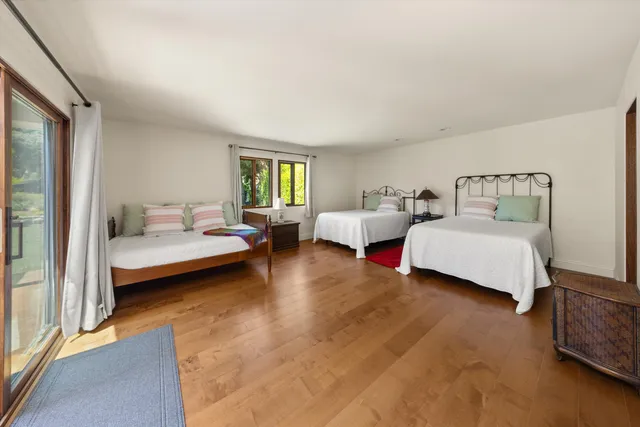 a spacious bedroom with a bed and window