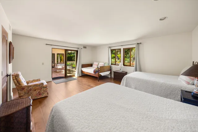 a bedroom with two beds and a couch