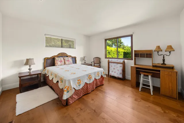 a bed sitting in a bedroom next to a window