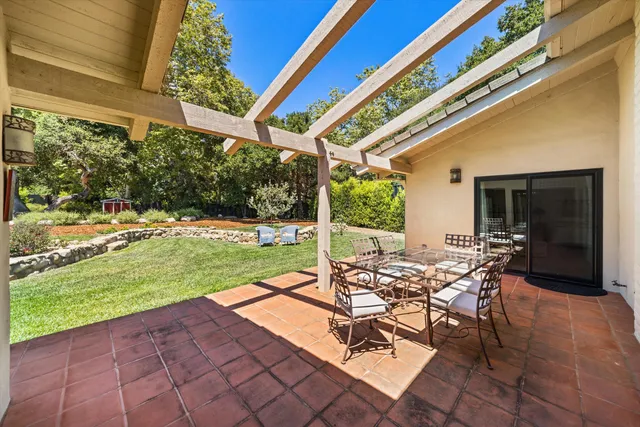 a view of a patio with a table and chairs
