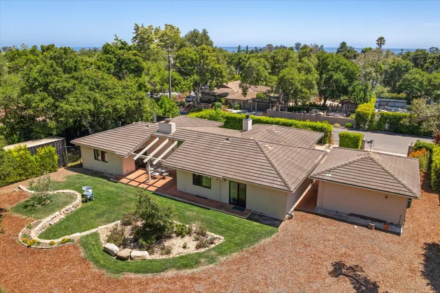 an aerial view of a house with swimming pool garden and patio