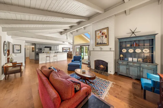 a living room with furniture fireplace and wooden floor
