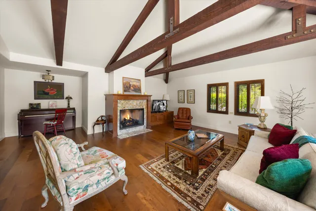 a living room with furniture fireplace and a table