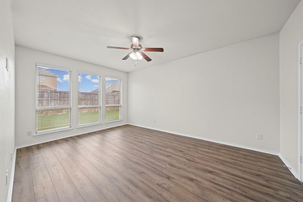 1205 Crest Ridge Drive Glenn Heights, TX 75154 - Photo 11 of 26 a view of empty room with wooden floor and fan