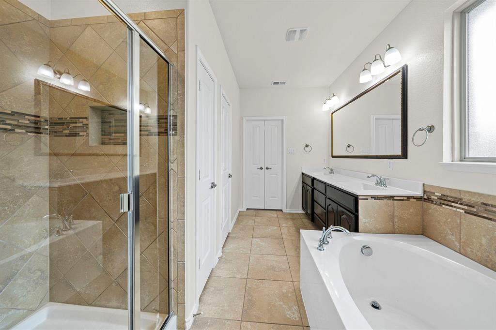 1205 Crest Ridge Drive Glenn Heights, TX 75154 - Photo 14 of 26 a spacious bathroom with a tub shower and sink