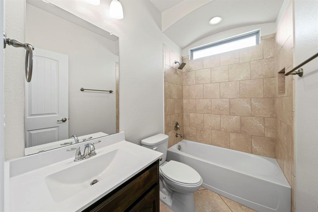 1205 Crest Ridge Drive Glenn Heights, TX 75154 - Photo 18 of 26 a bathroom with a sink mirror toilet and bathtub