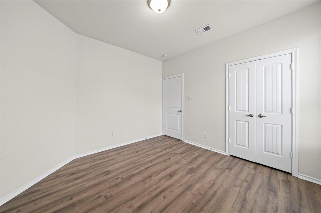 1205 Crest Ridge Drive Glenn Heights, TX 75154 - Photo 20 of 26 a view of an empty room with wooden floor