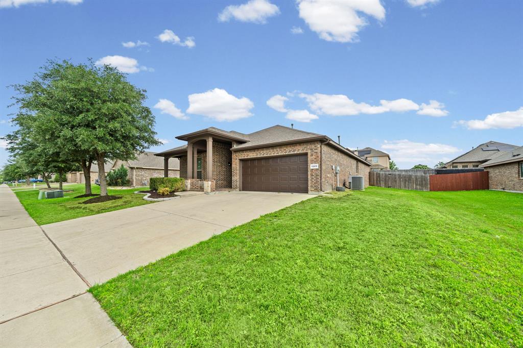 1205 Crest Ridge Drive Glenn Heights, TX 75154 - Photo 22 of 26 a front view of house with yard and green space