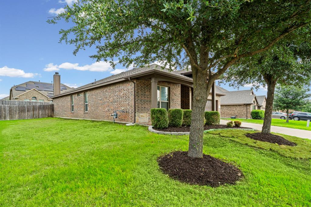 1205 Crest Ridge Drive Glenn Heights, TX 75154 - Photo 23 of 26 a front view of a house with garden
