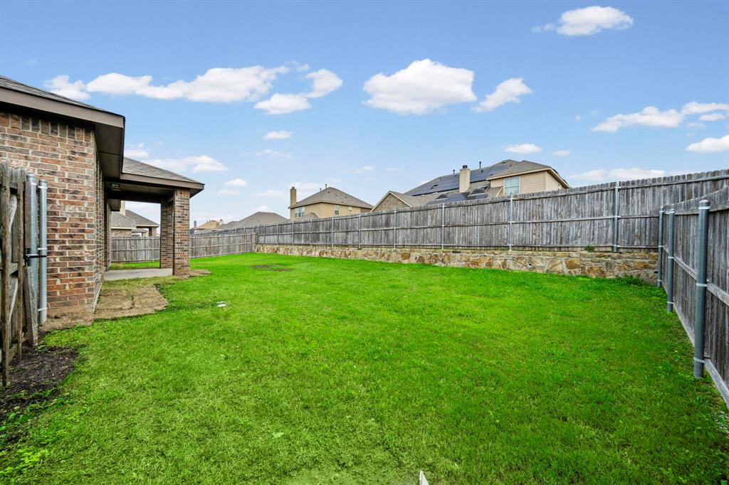 1205 Crest Ridge Drive Glenn Heights, TX 75154 - Photo 24 of 26 a view of a house with a yard and sitting area