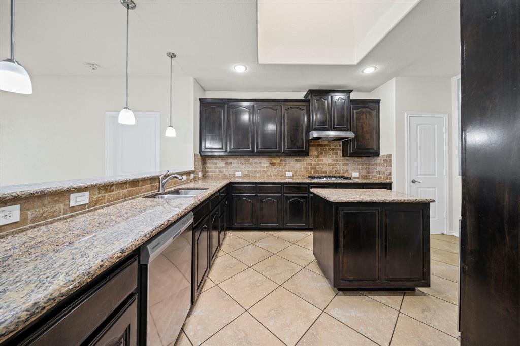 1205 Crest Ridge Drive Glenn Heights, TX 75154 - Photo 6 of 26 a kitchen with a sink and cabinets