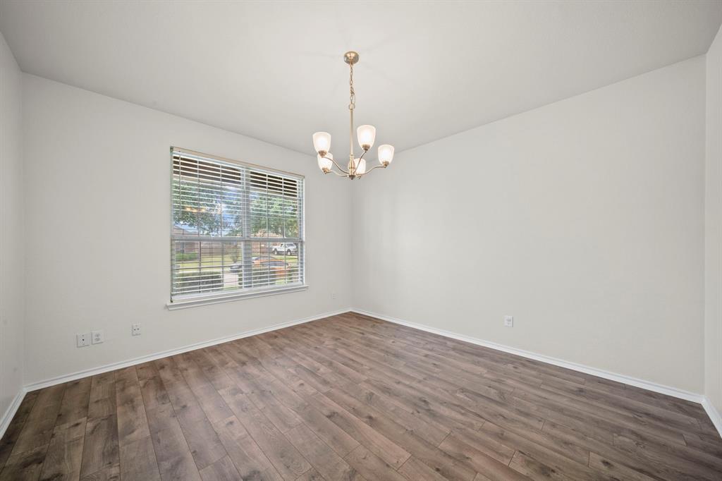 1205 Crest Ridge Drive Glenn Heights, TX 75154 - Photo 9 of 26 a view of a livingroom with wooden floor and a chandelier