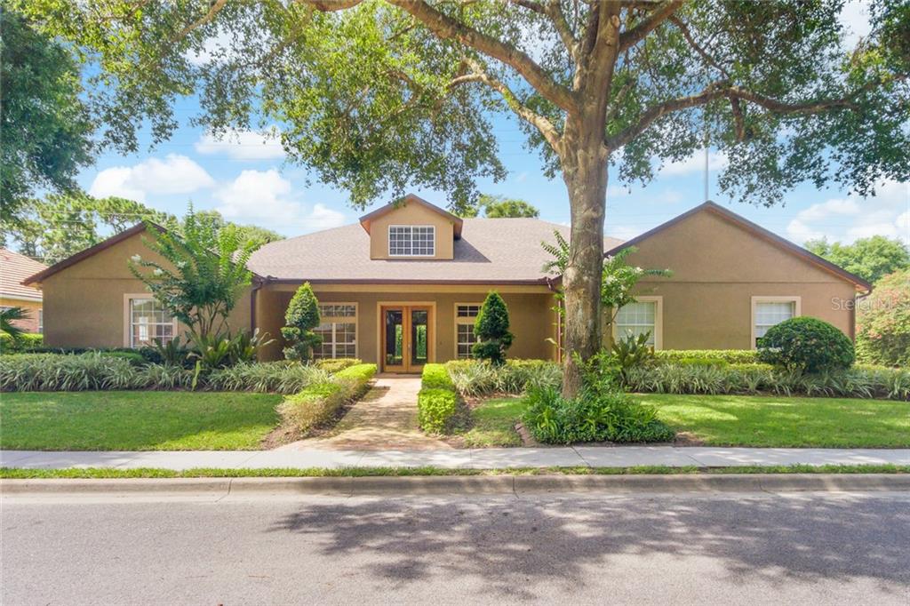 2445 Stoneview Road Orlando, FL 32806 - Photo 1 of 1 a front view of a house with a garden