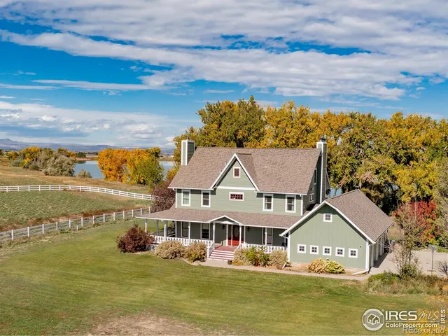 a view of house with yard and ocean view