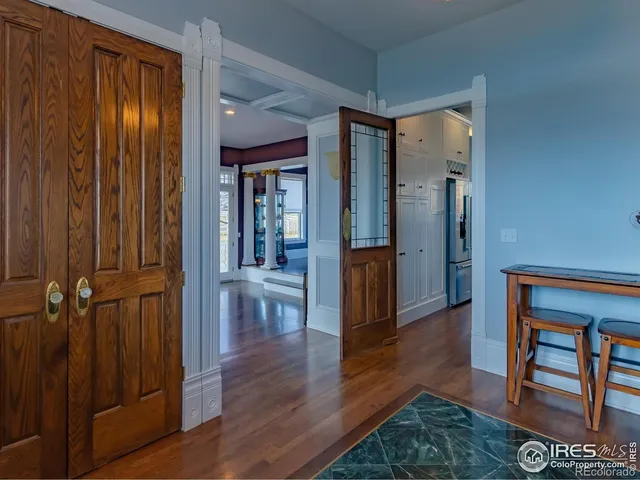 a dining room with furniture a chandelier and wooden floor