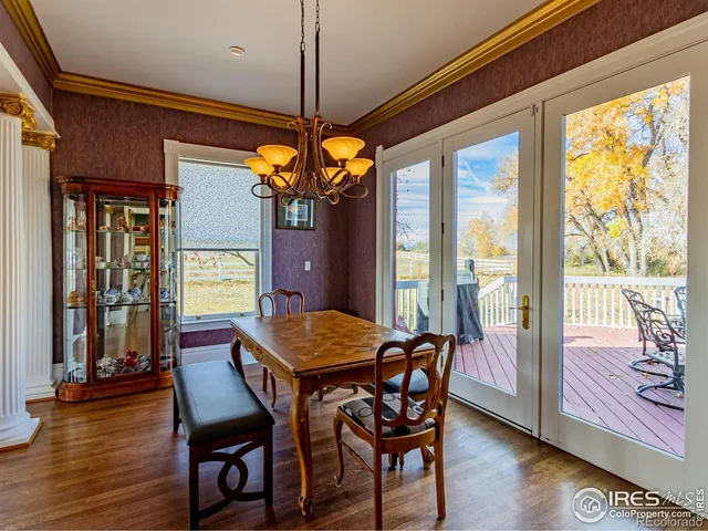 a kitchen with stainless steel appliances granite countertop a sink a stove and a wooden floors