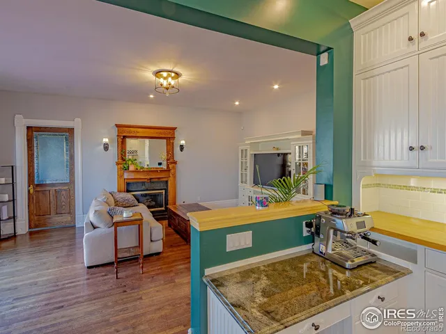 a living room with furniture flat screen tv and wooden floor