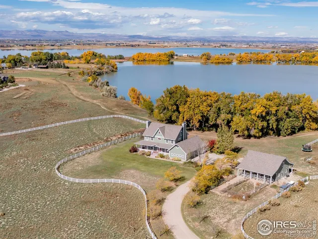 an aerial view of a house with a swimming pool outdoor seating yard and mountain view in back