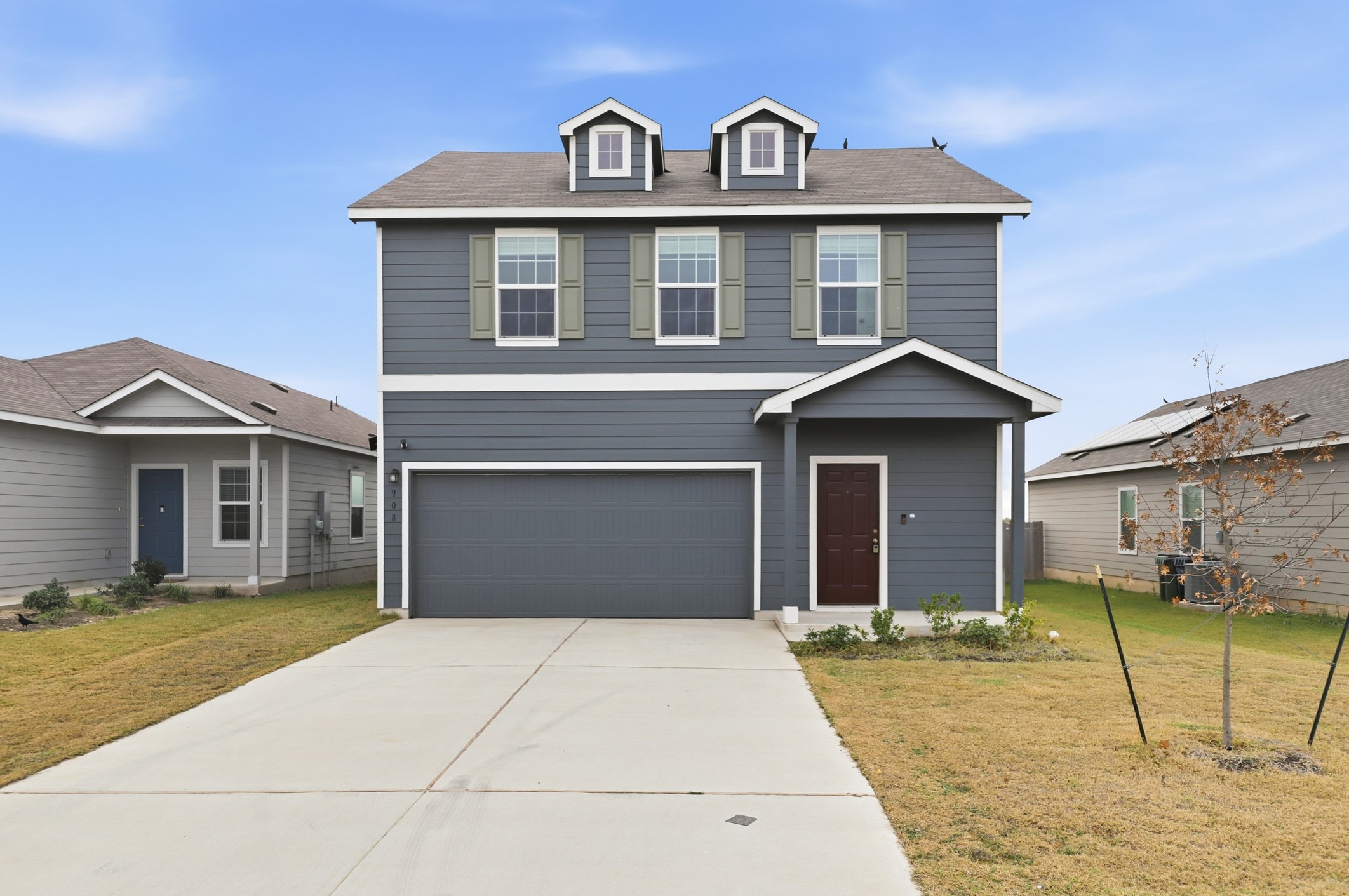 a front view of a house with a yard and garage