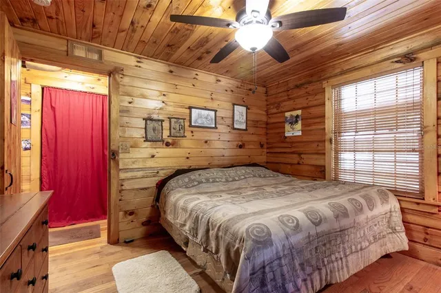 a bed sitting in a bedroom next to a window