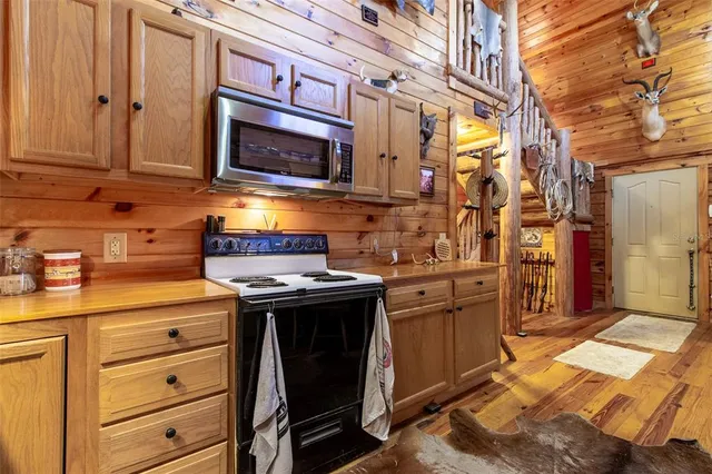 a kitchen with stainless steel appliances granite countertop a stove and a microwave