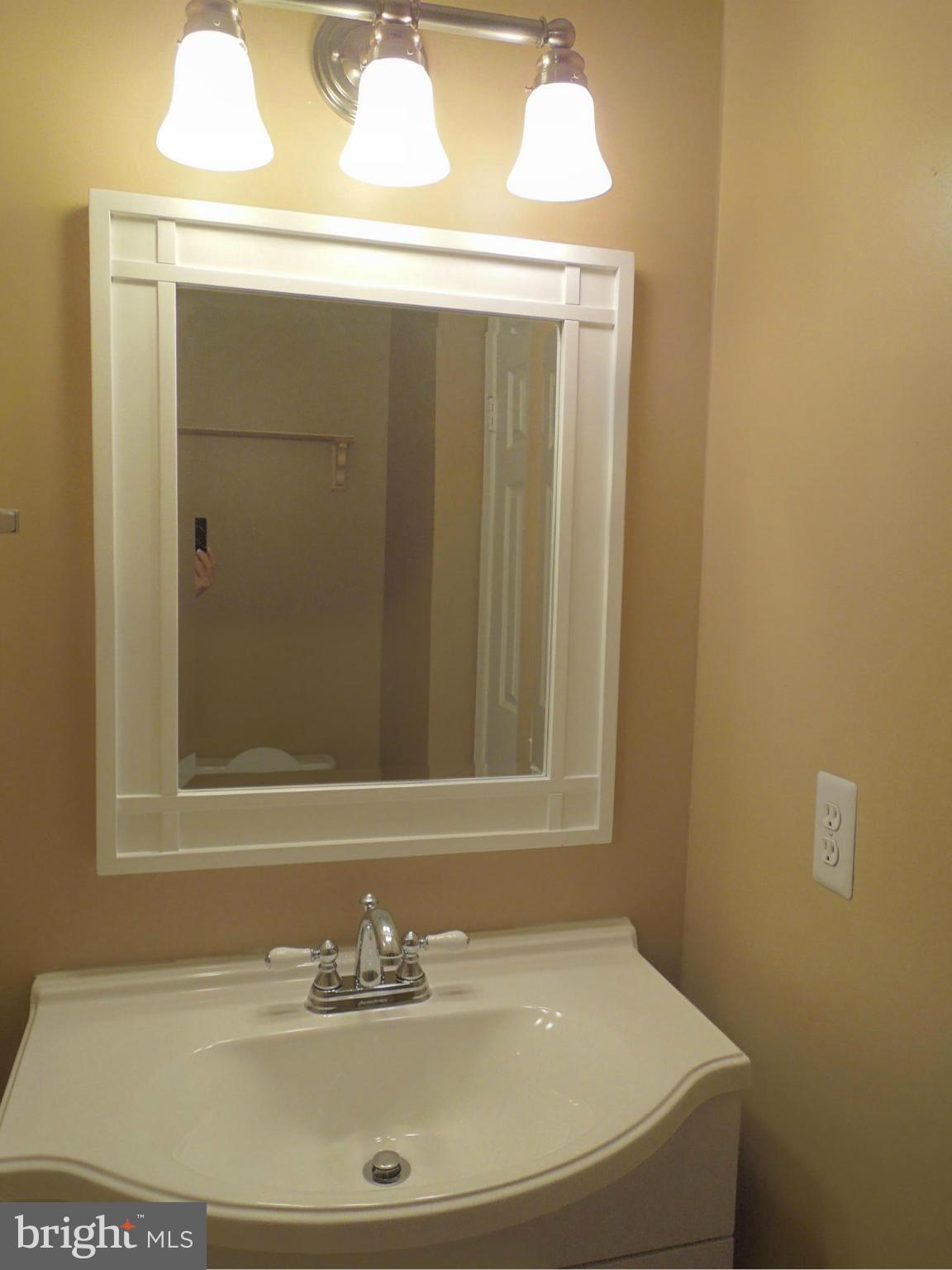 14853 Basingstoke Loop Centreville, VA 20120 - Photo 15 of 30 a bathroom with a sink and a mirror