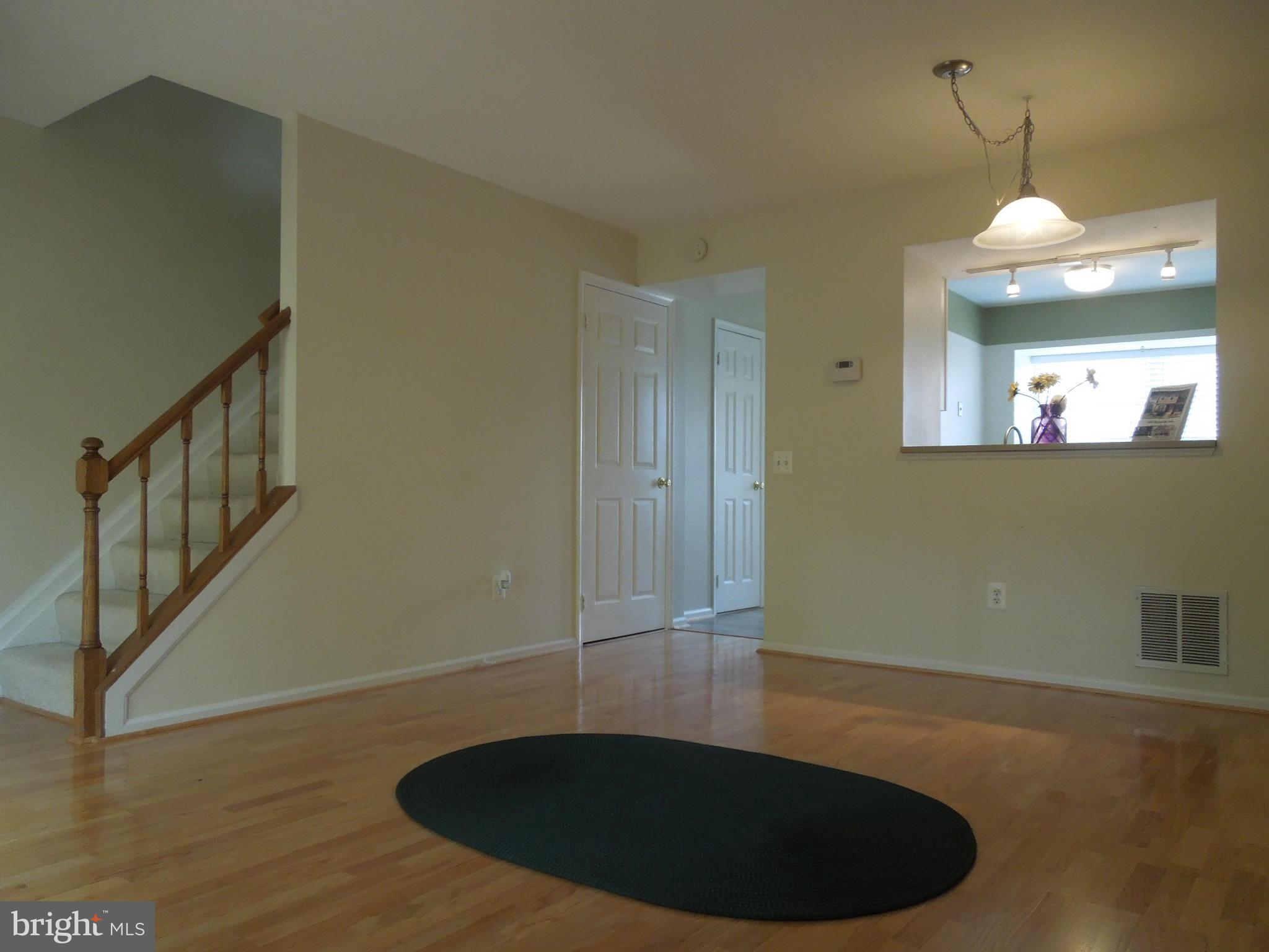 14853 Basingstoke Loop Centreville, VA 20120 - Photo 10 of 30 a view of a livingroom with wooden floor and staircase