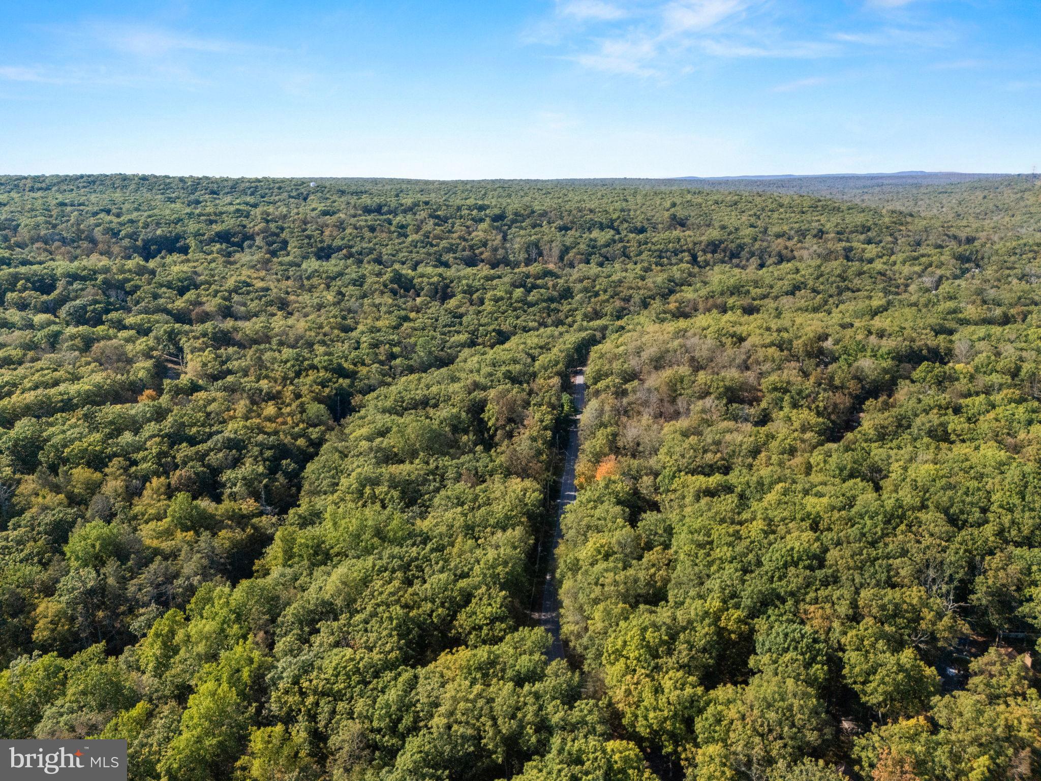 244 Canterbury Road Bushkill, PA 18324 - Photo 42 of 45 Lush green hills under a clear blue sky.
