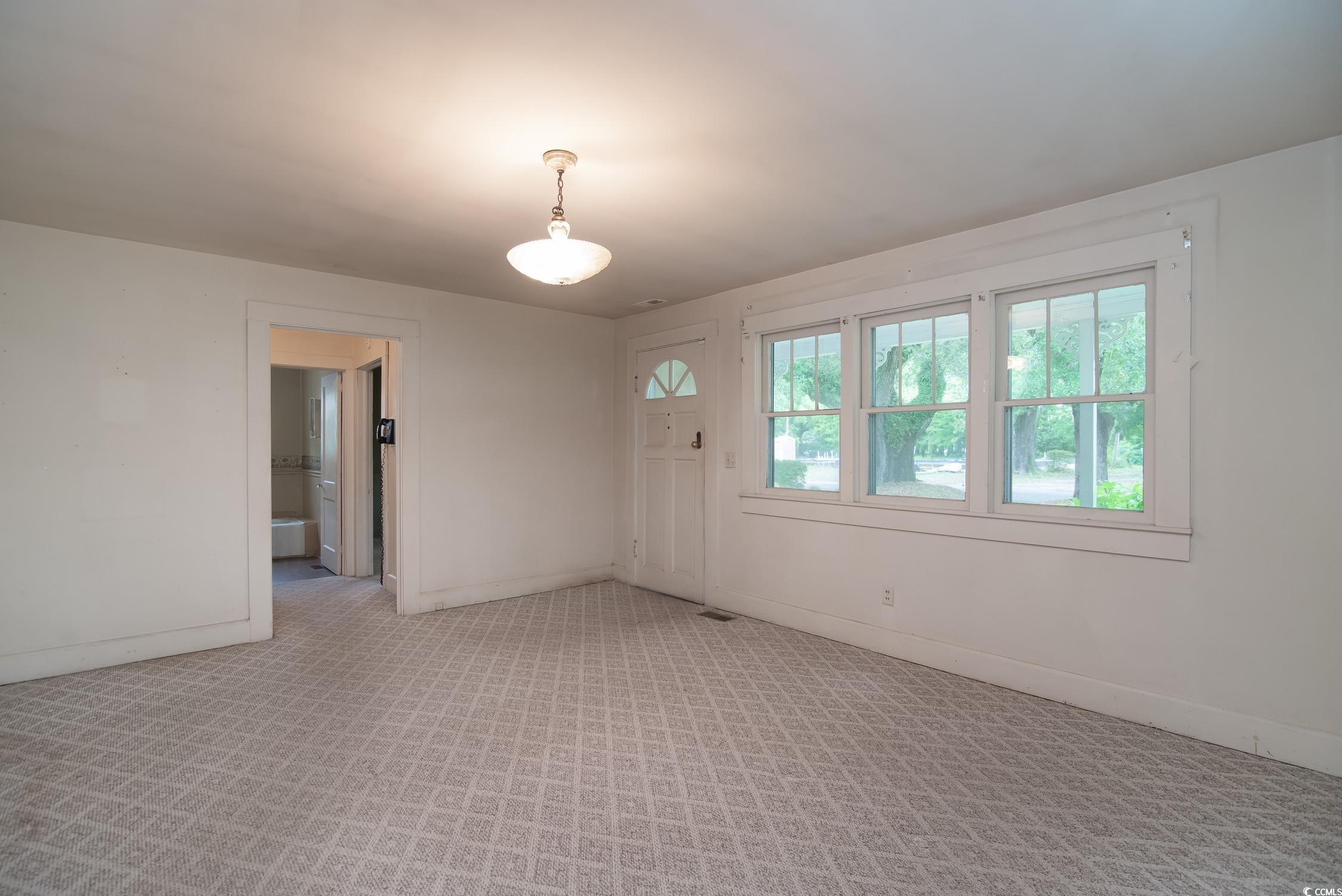 704 North Congdon Street Georgetown, SC 29440 - Photo 16 of 35 Empty room with baseboards and light colored carpet