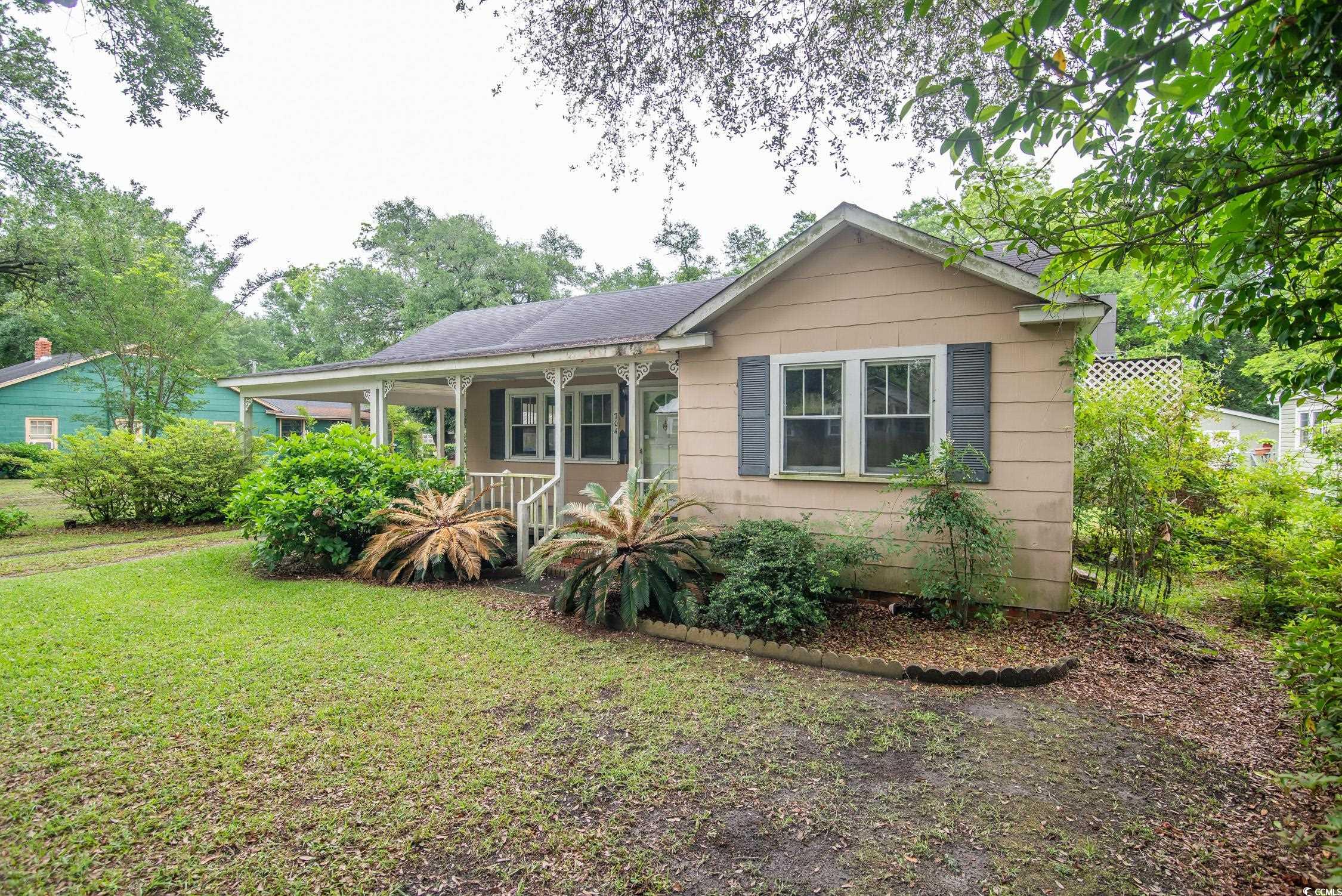 704 North Congdon Street Georgetown, SC 29440 - Photo 2 of 35 View of front of house with a porch and a front lawn