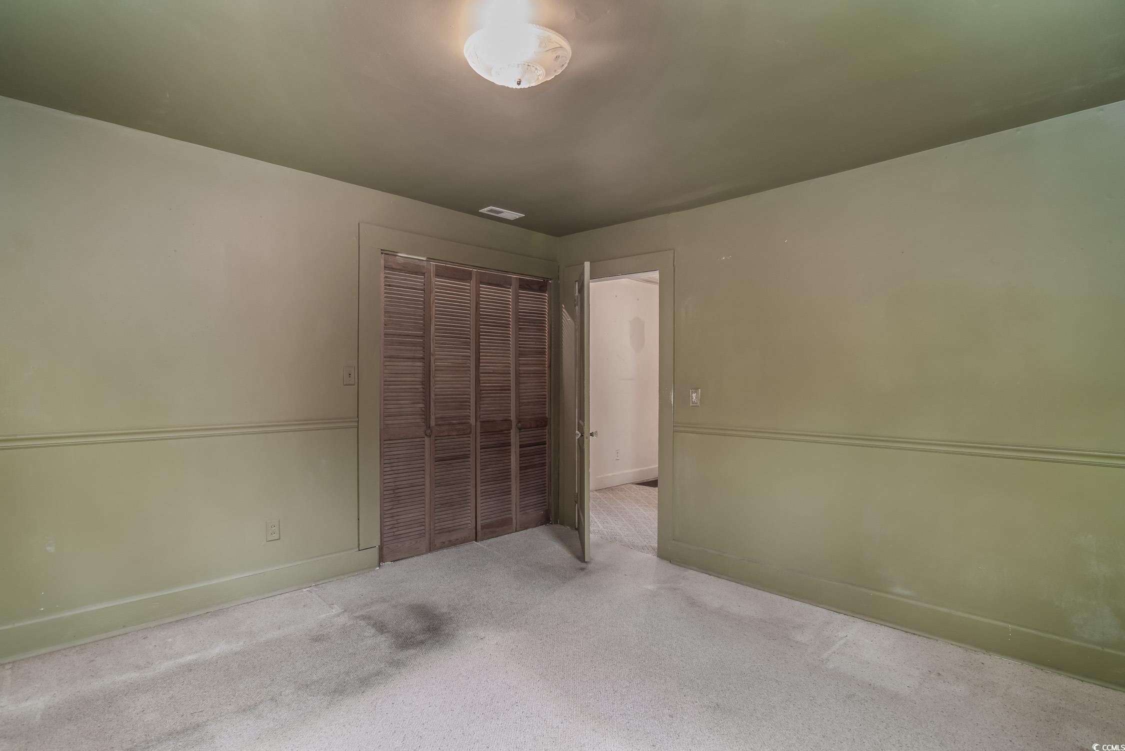 704 North Congdon Street Georgetown, SC 29440 - Photo 23 of 35 Unfurnished bedroom featuring a closet, carpet floors, and baseboards