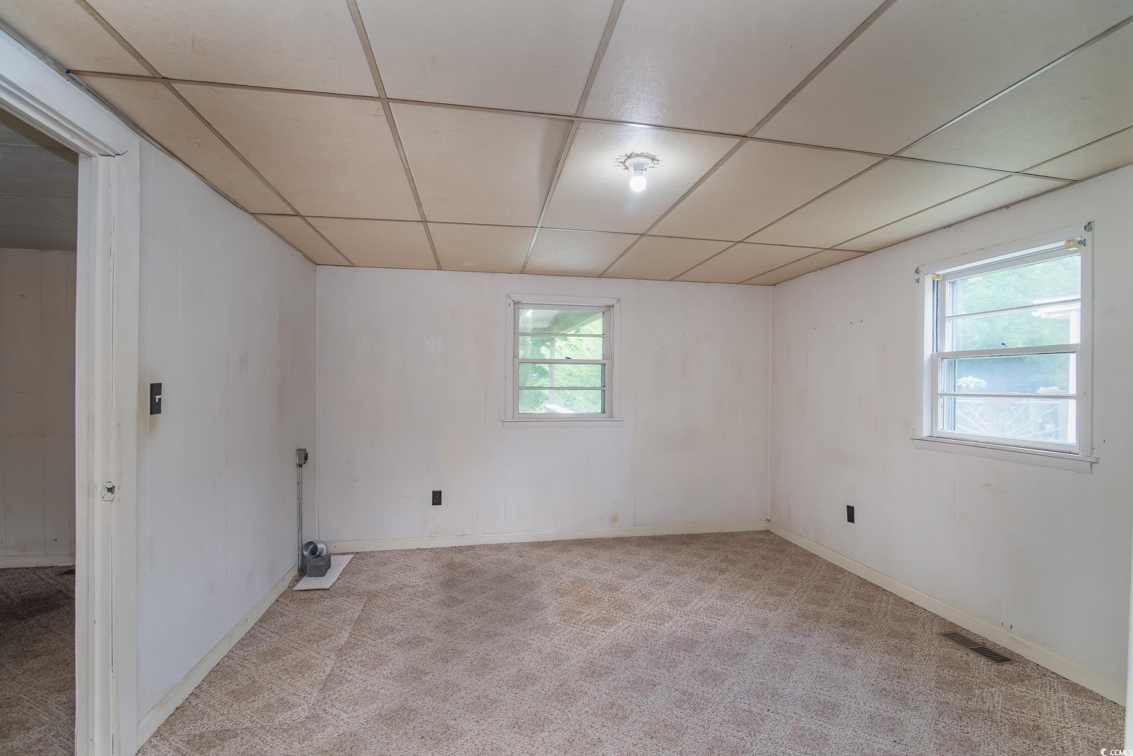 704 North Congdon Street Georgetown, SC 29440 - Photo 26 of 35 Unfurnished room with a drop ceiling, light carpet, and baseboards