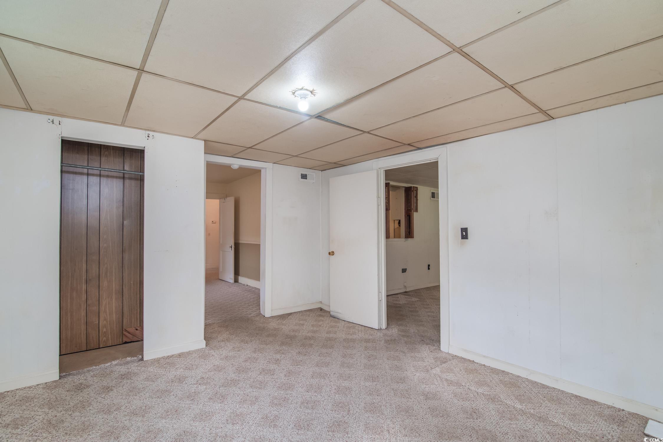 704 North Congdon Street Georgetown, SC 29440 - Photo 27 of 35 Spare room featuring a paneled ceiling, light carpet, and baseboards