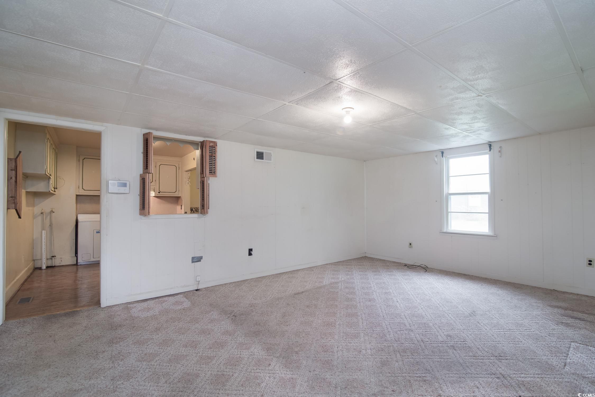 704 North Congdon Street Georgetown, SC 29440 - Photo 28 of 35 Carpeted empty room featuring a paneled ceiling and baseboards