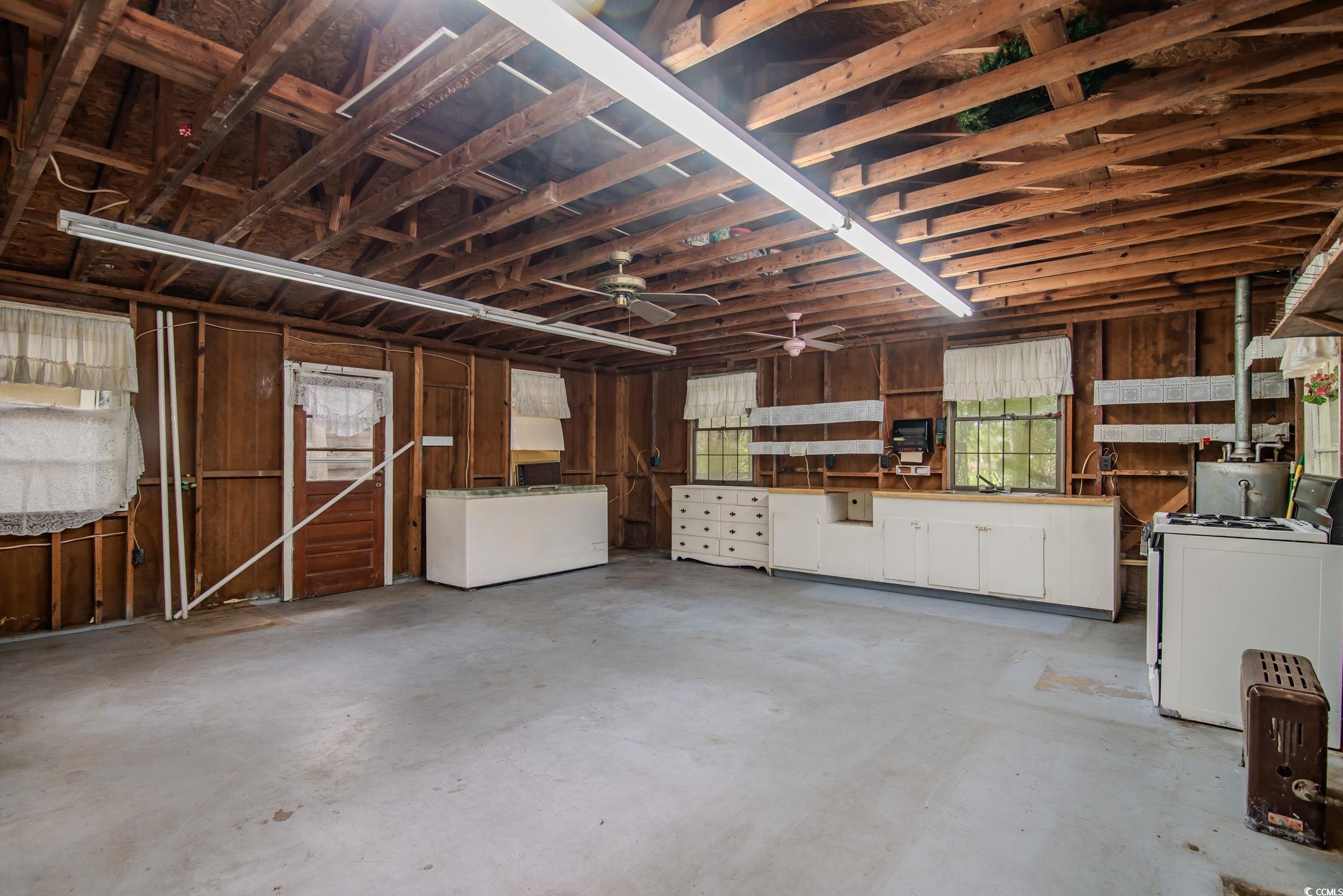 704 North Congdon Street Georgetown, SC 29440 - Photo 33 of 35 Garage with a ceiling fan, fridge, and a sink