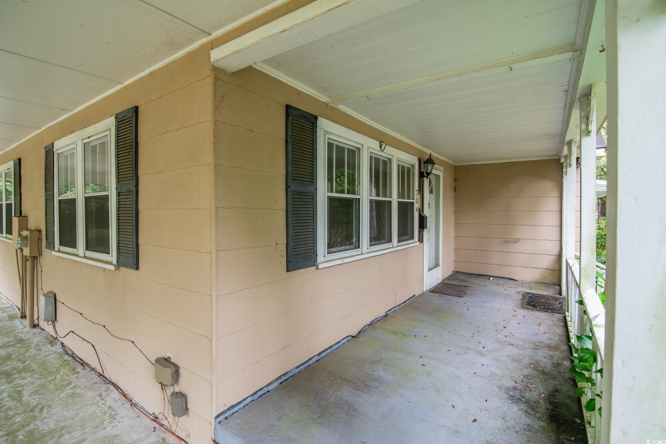704 North Congdon Street Georgetown, SC 29440 - Photo 5 of 35 View of property exterior with covered porch and concrete block siding