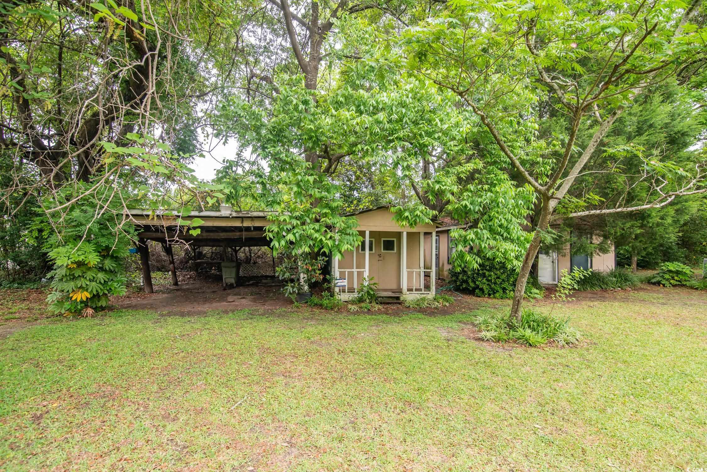 704 North Congdon Street Georgetown, SC 29440 - Photo 8 of 35 View of grassy yard featuring a carport