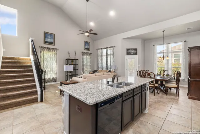 a kitchen with granite countertop center island wooden floor and stainless steel appliances
