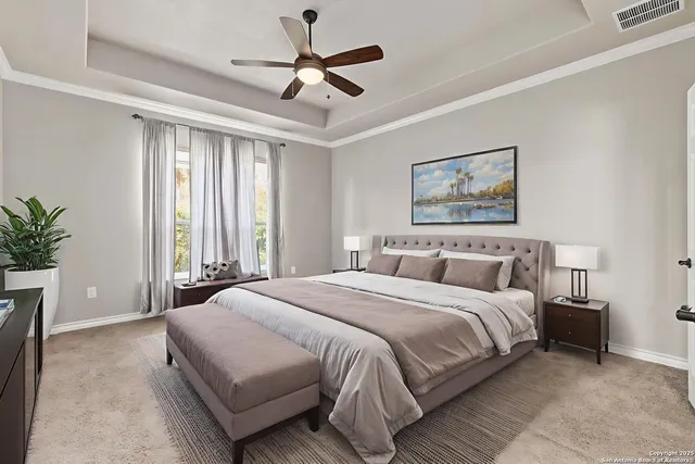 a spacious bedroom with a large bed and a chandelier