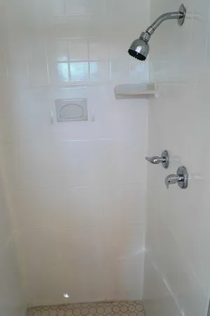 a view of room with window and wooden floor