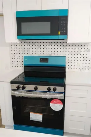 a kitchen with a sink a stove and a microwave