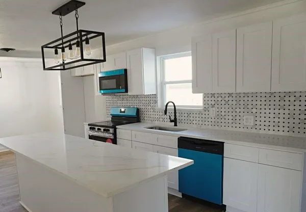 a kitchen with a stove and a white cabinets