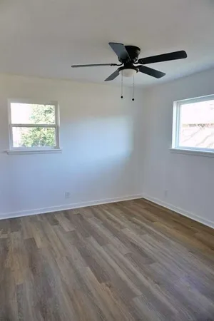 wooden floor in an empty room with a window