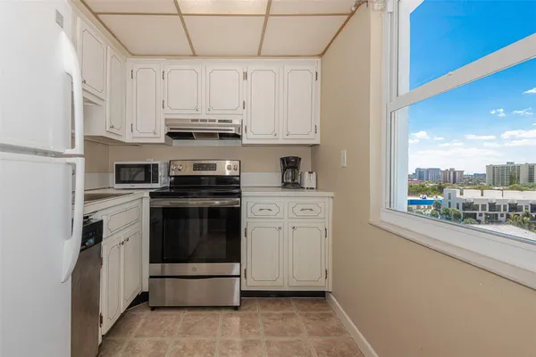 a view of a balcony with two chairs and a potted plant